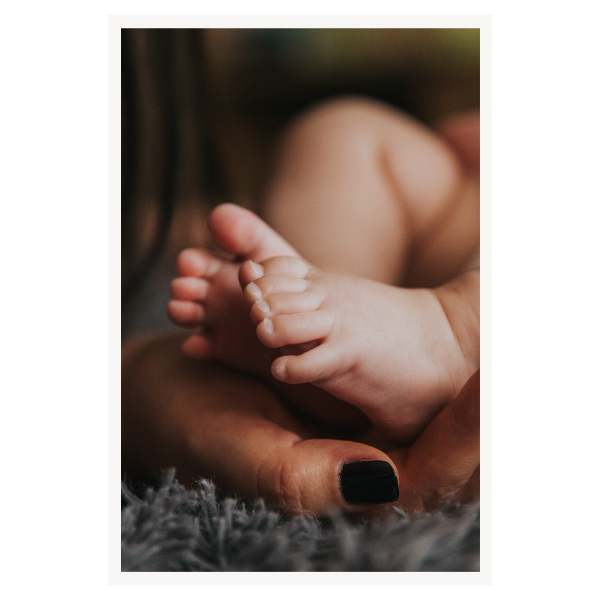 A parent holding their newborn baby close in warm natural light